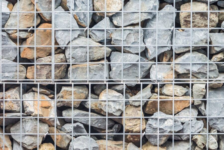 Gabion retaining wall made of wire mesh baskets filled with rock