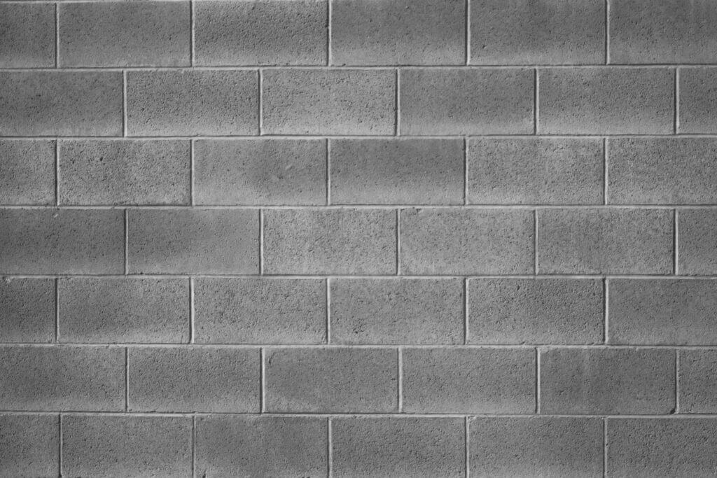Reinforced concrete masonry block wall designed for strength and structural stability in commercial and residential applications