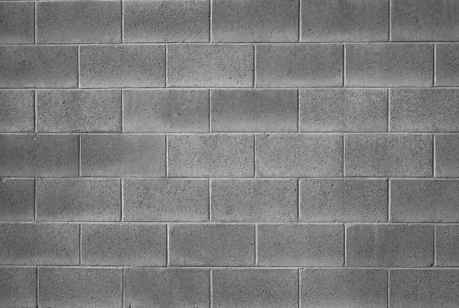 Reinforced concrete masonry block wall designed for strength and structural stability in commercial and residential applications