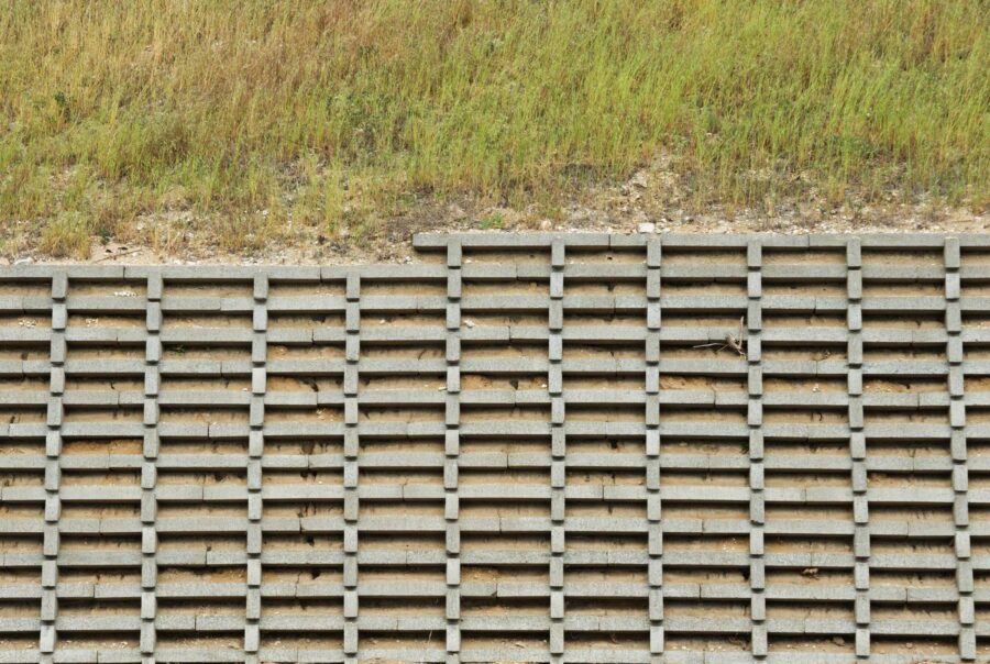 Crib retaining wall with interlocking concrete cells on a roadside slope